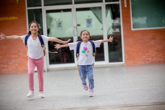 Back to school. Cute Asian child girl with a backpack running and going to school with fun photo