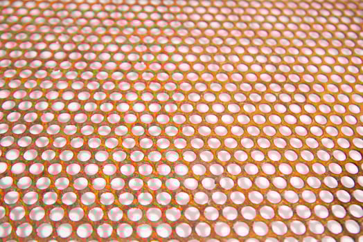 a close up of a metal mesh with holes photo