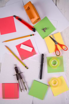 a table with a bunch of different colored paper photo