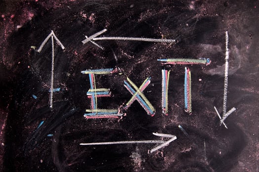 exit sign on blackboard with arrows photo
