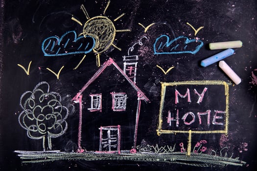 a chalkboard with a house, a sign and a sun photo