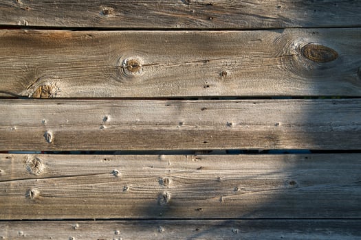 a close up of a wooden wall with a red fire hydrant photo