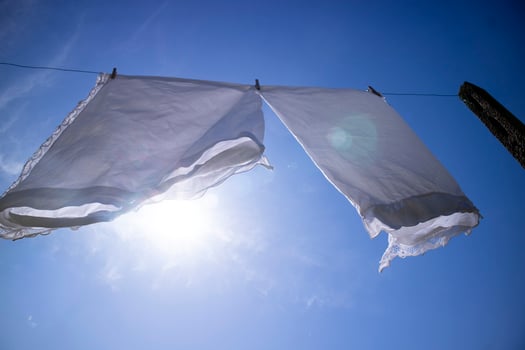 House linen hanging out in the sun photo