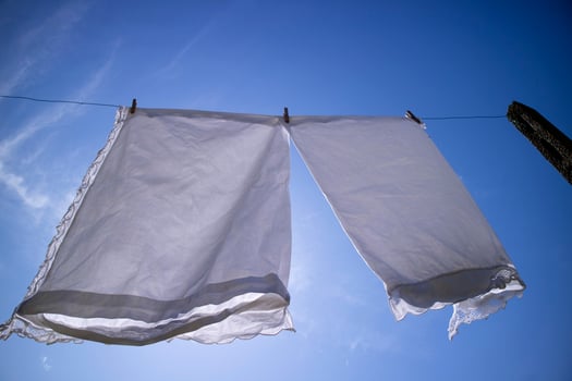 House linen hanging out in the sun photo