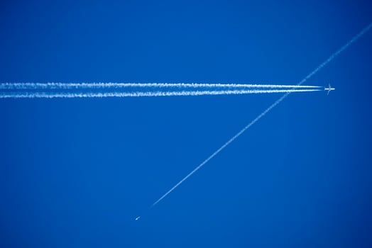 The trails in the sky that leave the planes in flight photo