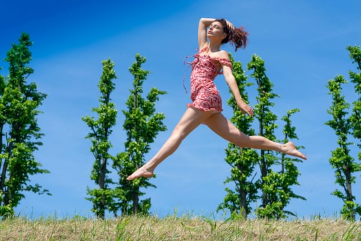 Girl jumping in nature in spring season photo