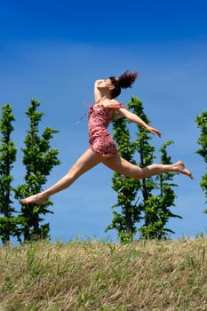 Girl jumping in nature in spring season photo
