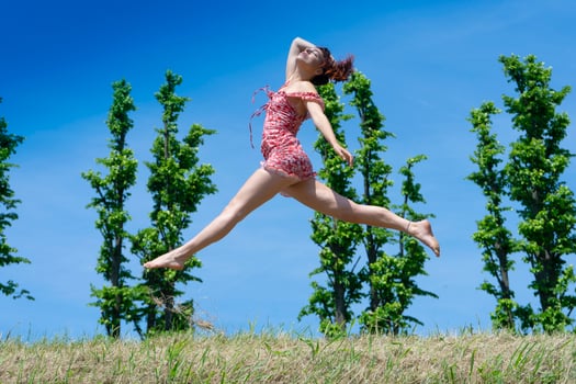 Girl jumping in nature in spring season photo
