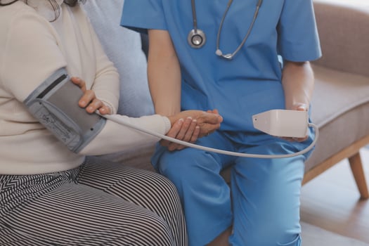 Doctor and patient talking while sitting at the desk in hospital office, closeup of human hands. Medicine and health care concept photo