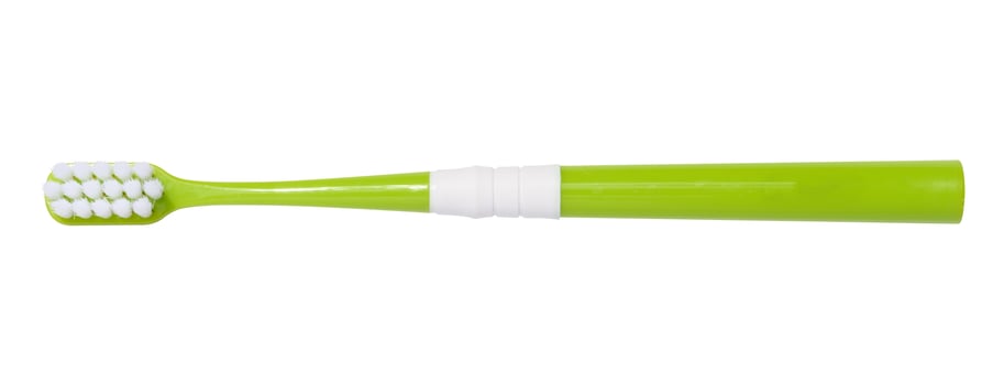 Green plastic toothbrush isolated on white background, top view photo