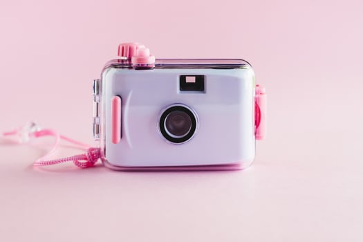 Camera waterproof toy on pink background photo