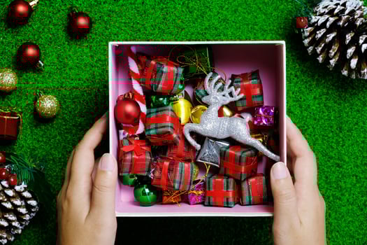 woman hand holding christmas decoration holidays and people concept. photo