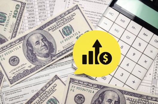 chart symbol on yellow sticker with dollars and pen with calculator photo