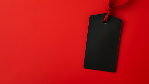 Black empty price tag on red background. Black Friday concept, template copyspace photo