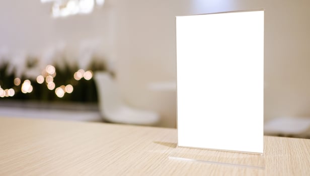 Menu frame standing on wood table in Bar restaurant cafe. space for text marketing promotion. photo