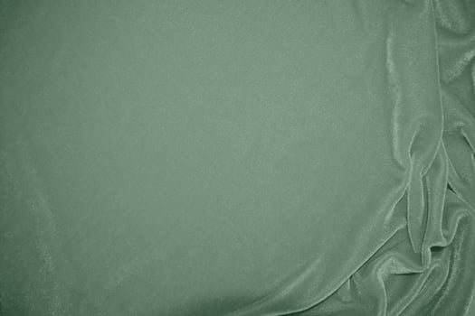 Olive green color velvet fabric texture used as background. Green color panne fabric background of soft and smooth textile material. crushed velvet .luxury golden tone for silk.pink gold photo