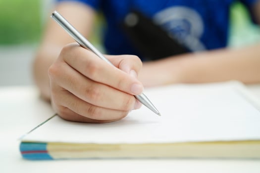 Asian teenage student write homework, study lesson for exam online learning education. photo