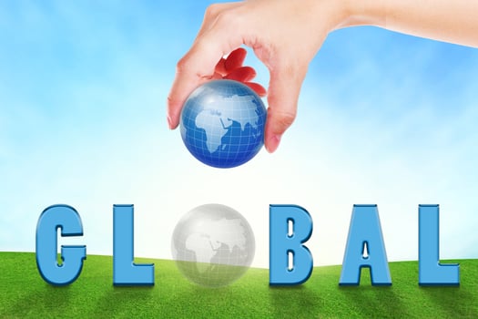Female hand filling text global  on grassland. photo
