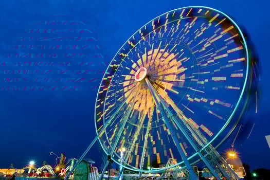 Ferris wheel spin outdoor motion at twilight. photo