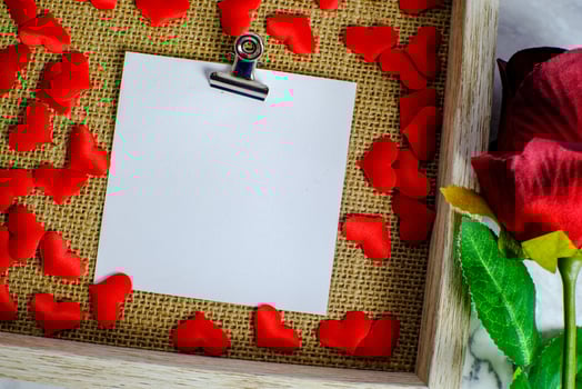 Valentines day background. Red rose with message card of Love romantic couple. photo