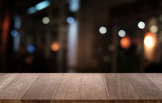 Empty dark wooden table in front of abstract blurred bokeh background of restaurant . can be used for display or montage your products.Mock up for space. photo