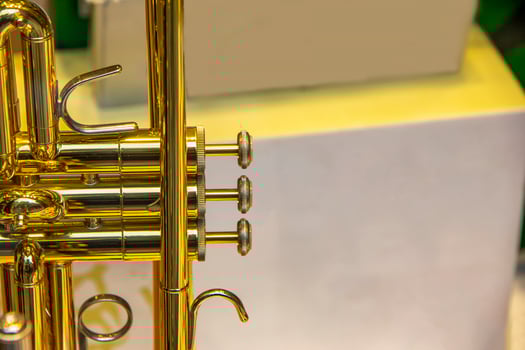 A part of the stunning golden trumpet with brass details. Close up of trumpet finger buttons valves photo