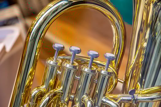 A part of the classical wind instrument with brass details. Close up of trumpet finger buttons valves photo