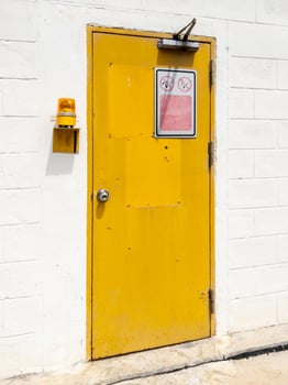 The yellow metal door with the door closes. photo