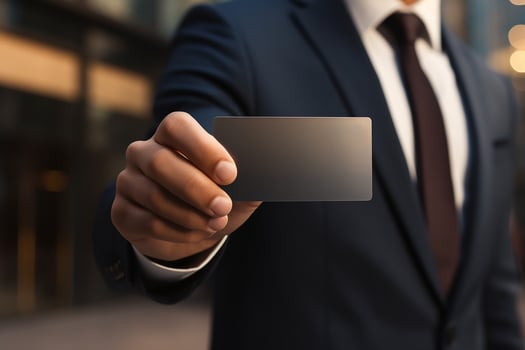 Businessman Wearing Suit Showing Business Card as Identification and Personal Identity photo