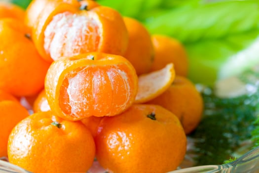 Close up orange on dish glass with green leaf. photo