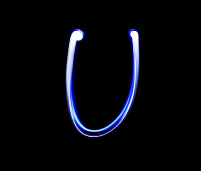 U Uniform alphabet hand writing blue light  over black background. photo