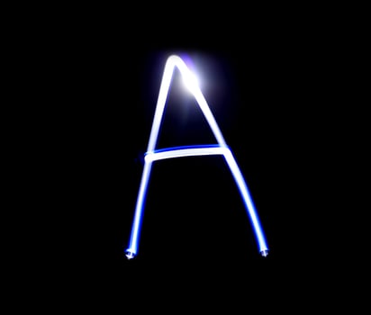 A Able alphabet hand writing blue light  over black background. photo