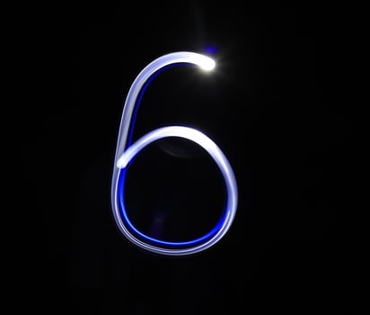 Six blue light digit hand writing over black background. photo