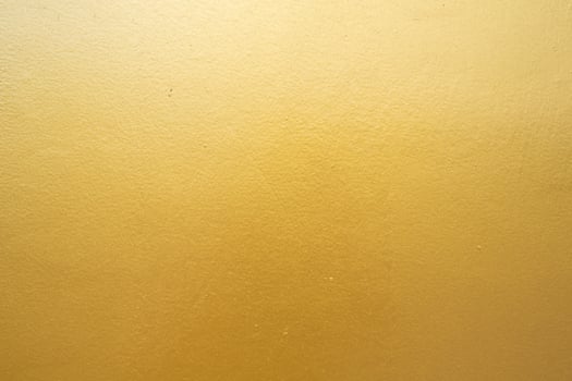 Gold concrete wall on background texture. photo