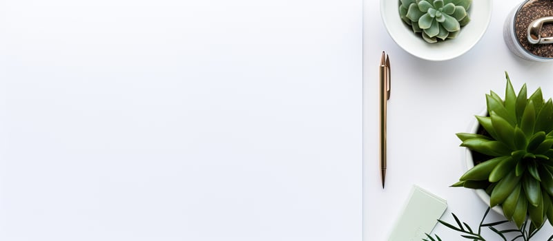 Photo of a minimalistic desk with a white sheet of paper, a plant, and a pair of scissors with copy space