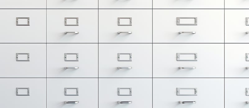 Photo of a minimalist white drawer set with square knobs with copy space
