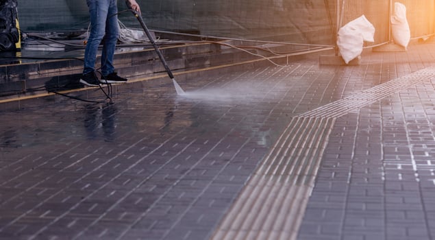 Outdoor floor cleaning with high pressure water jet. photo