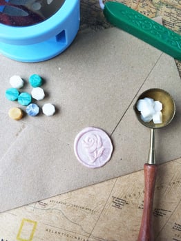 Old letter with wax seal and wax seal on old map background. photo