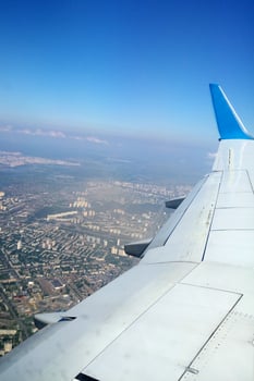 Plane wing with a city under it photo