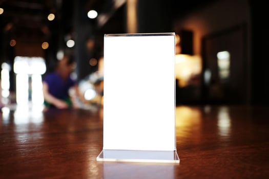 Menu frame standing on wood table in Bar restaurant cafe. space for text marketing promotion. photo