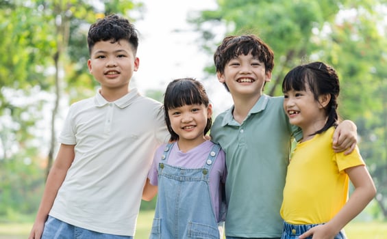 group of cute asian kids having fun in the park photo