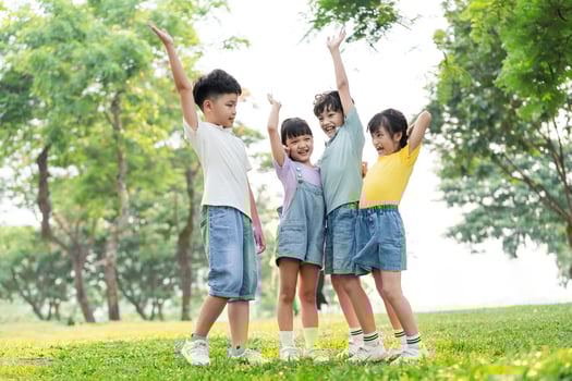 group of cute asian kids having fun in the park photo