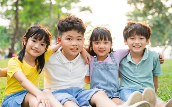 group of cute asian kids having fun in the park photo