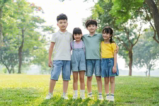 group of cute asian kids having fun in the park photo