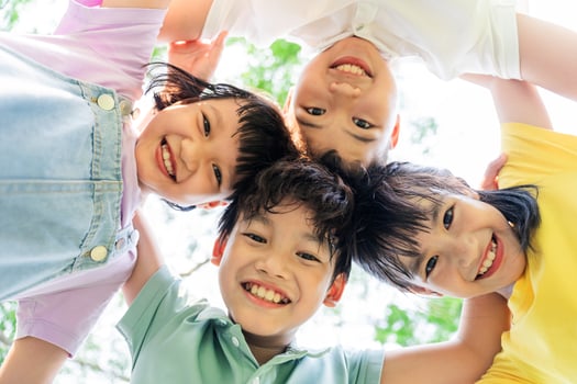 group of cute asian kids having fun in the park photo