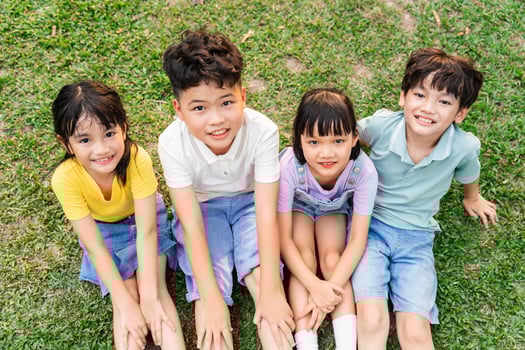 group of cute asian kids having fun in the park photo