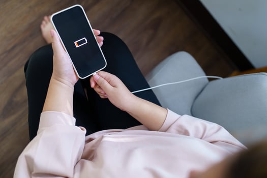 Woman hands Charging mobile phone battery with low battery. plugging a charger in a smart phone  with energy bank powerbank power charger Modern lifestyle energy technology concept photo