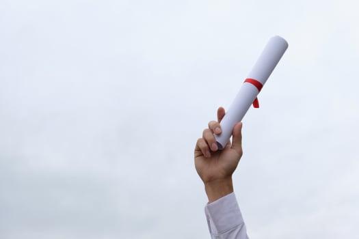 Student with congratulations, graduates wearing a graduation gown of university. photo