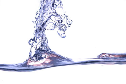 beautiful water waves in light blue color photographed on a white background. photo