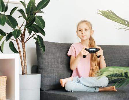 Girl playing video game at home photo
